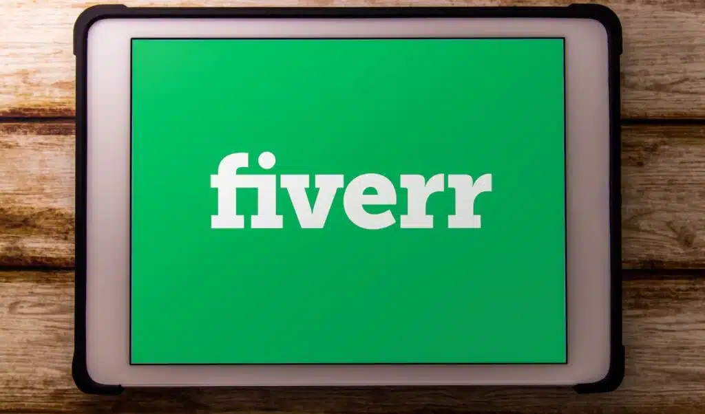 Closeup logo of Fiverr on tablet on faded shabby table.