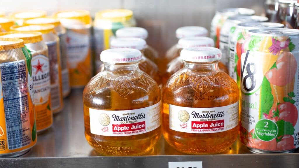 A view of several glass bottles of Martinelli's apple juice, seen at a local convenient store.