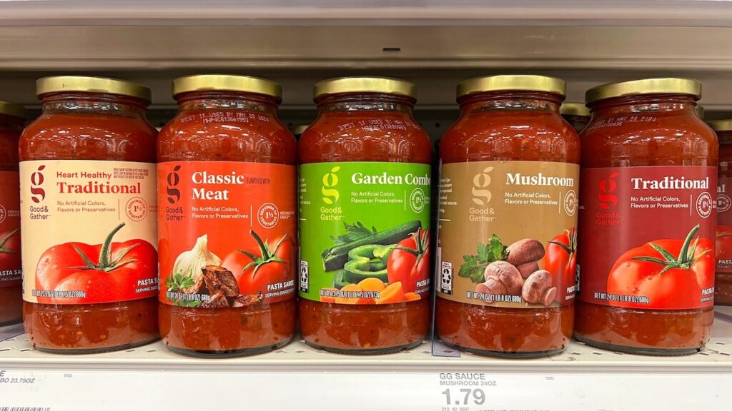 Grocery store shelf with jars of Good and Gather brand pasta sauces in various flavors.