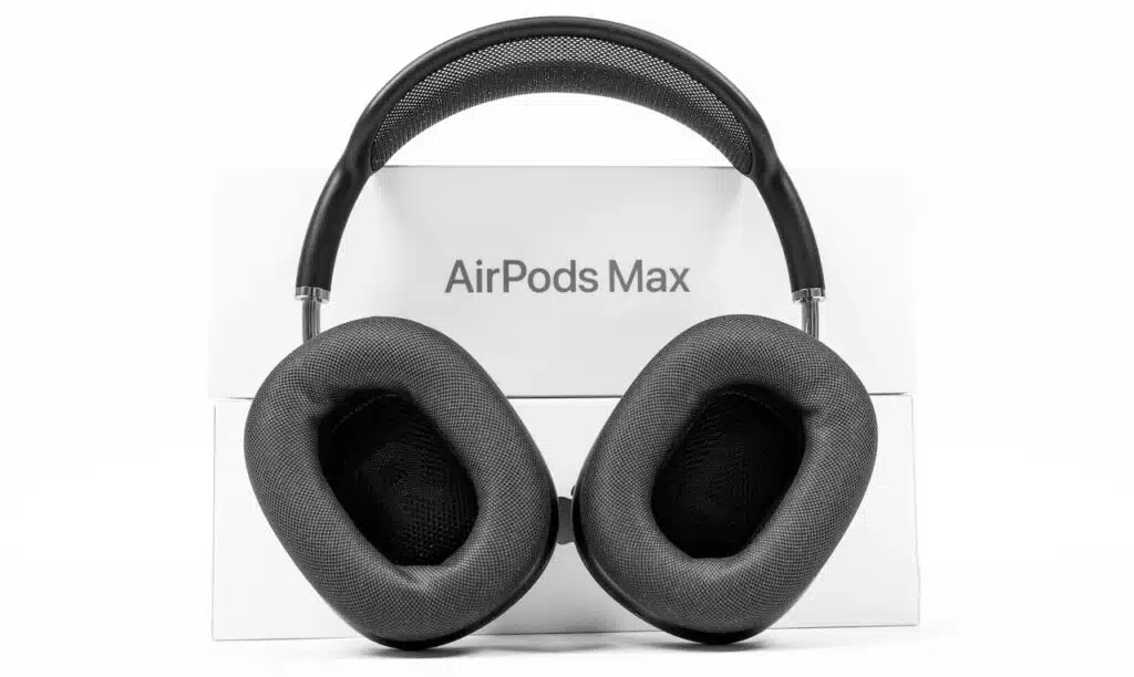 Apple AirPods Max of space gray color with modern cushion and soft flexible canopy is standing on white background with box.