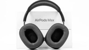 Apple AirPods Max of space gray color with modern cushion and soft flexible canopy is standing on white background with box.