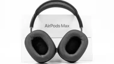 Apple AirPods Max of space gray color with modern cushion and soft flexible canopy is standing on white background with box.