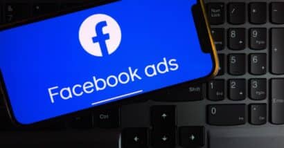 Facebook Ads logo displayed on smartphone screen in the office.