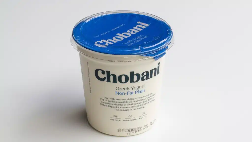 A tub of Chobani brand non-fat plain Greek Yogurt (32oz) isolated on a white background.