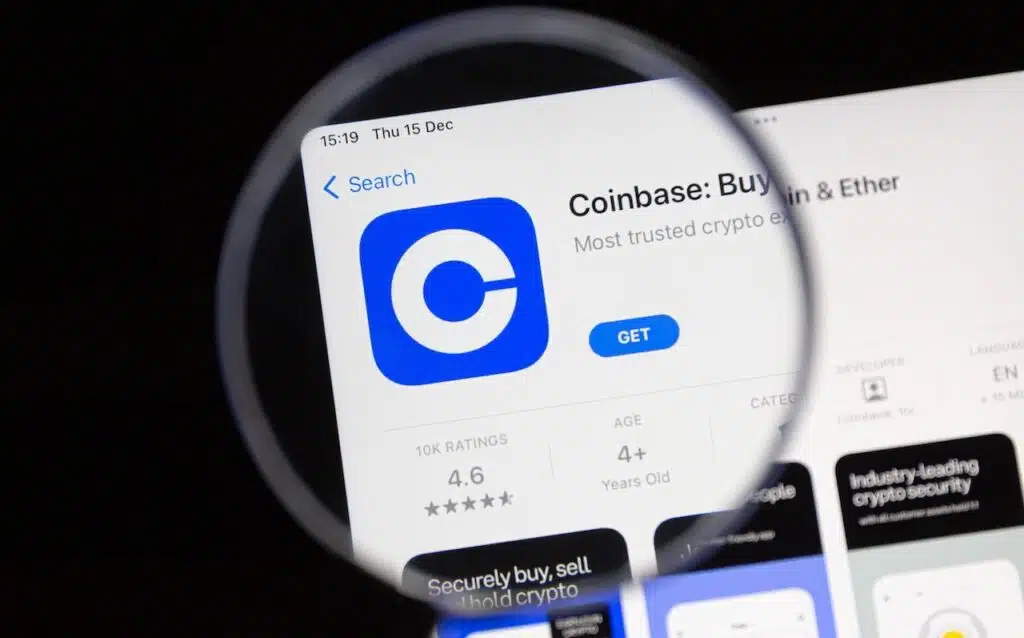 Coinbase app under a magnifying glass.