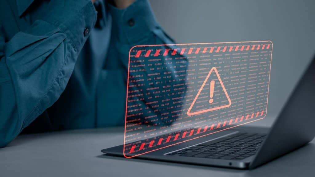 System hacked warning alert on computer laptop.