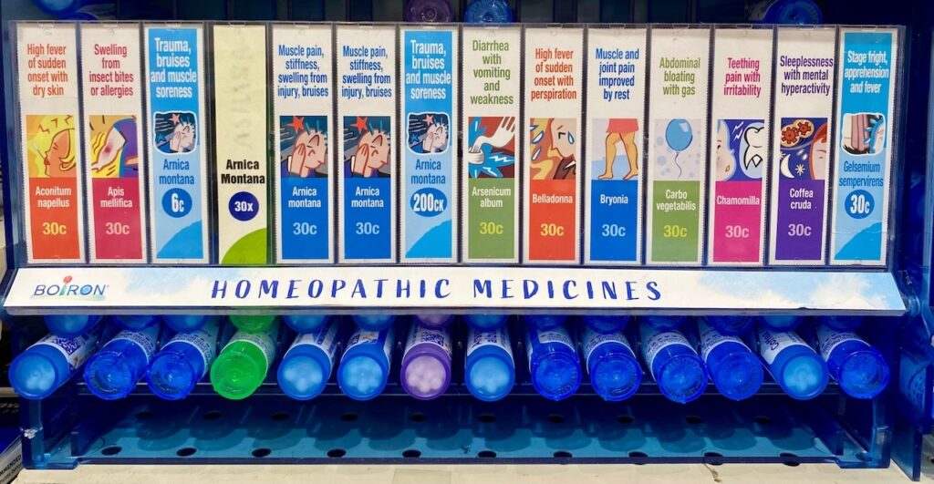 Homeopathic medicine display case with tubes of product.