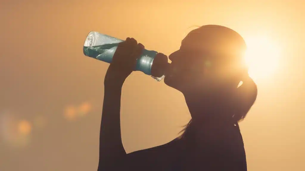Female drinking bottle of water.