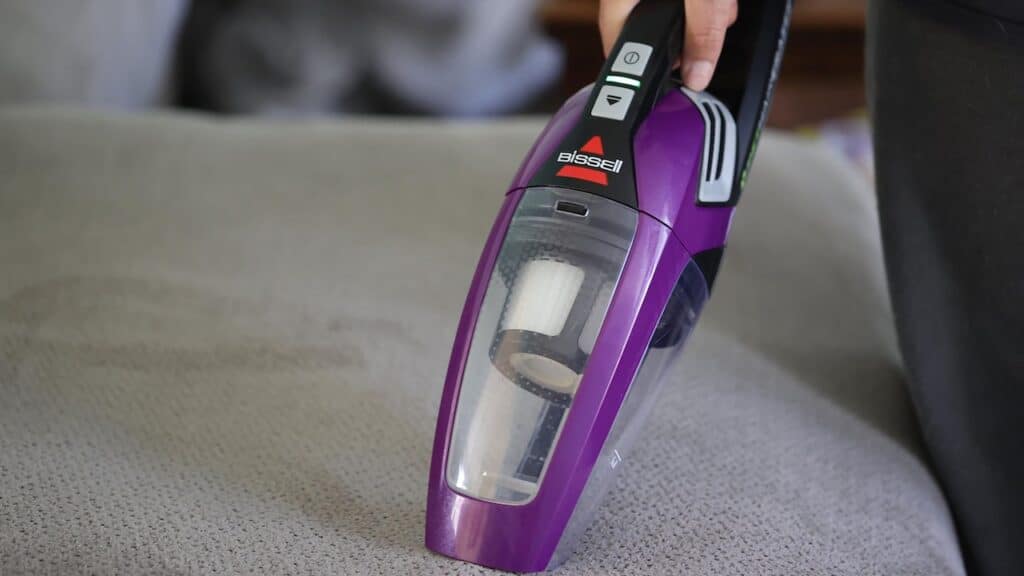 Adult cleaning house with a Bissell cordless sweeper