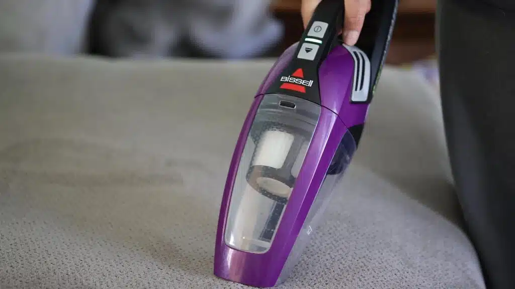 Adult cleaning house with a Bissell cordless sweeper