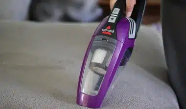 Adult cleaning house with a Bissell cordless sweeper