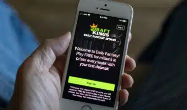 A man opens the DraftKings app from his iPhone. DraftKings is an American daily fantasy sports contest and sports betting operator.
