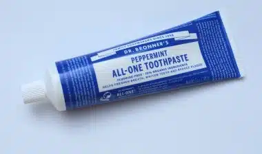 Peppermint Toothpaste brand DR. Bronner's All One, fluoride free, 70% organic ingredients.