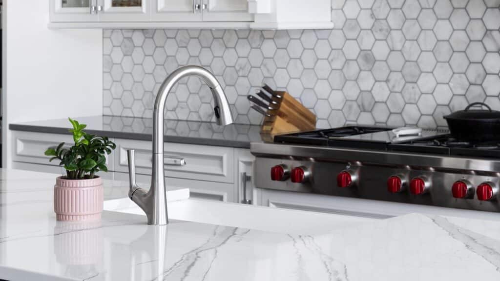 A kitchen sink detail, stainless faucet