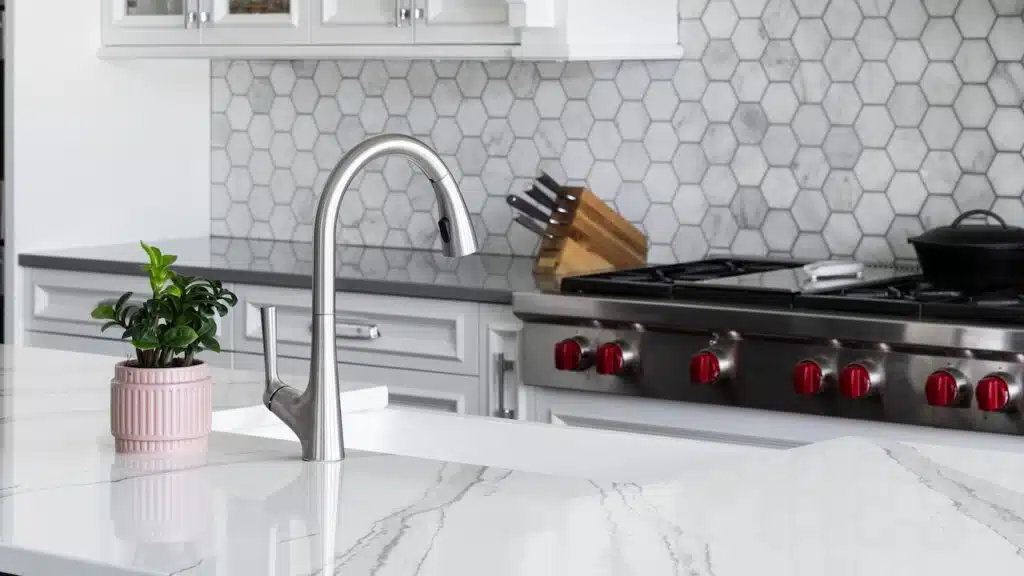 A kitchen sink detail, stainless faucet