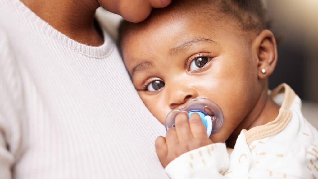 Mom, care and baby portrait with pacifier