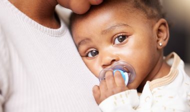Mom, care and baby portrait with pacifier