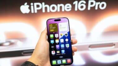 Apple launch new smartphone iPhone 16 Pro displayed in a Store. Hand holding iPhone 16 Pro.