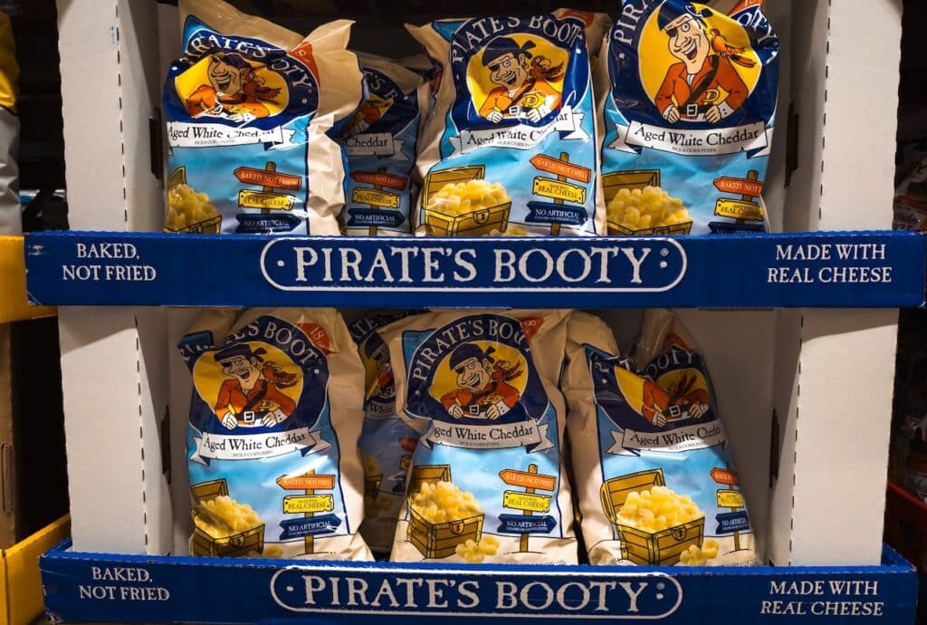 Bags of Pirates Booty Cheese Corn Puffs Snacks on Shelf at Grocery Food Store