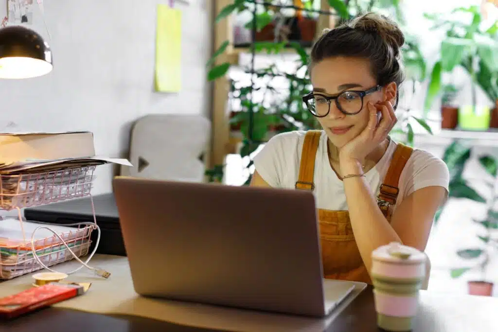 A woman using a laptop at home, representing the FullBeauty Brands class action lawsuit.