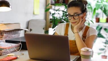A woman using a laptop at home, representing the FullBeauty Brands class action lawsuit.