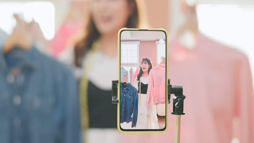 girl selling fashionable clothes on live stream