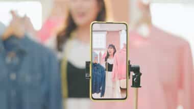 girl selling fashionable clothes on live stream