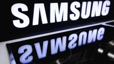 SAMSUNG logo on the stand is reflected in the electric cooker in the store.