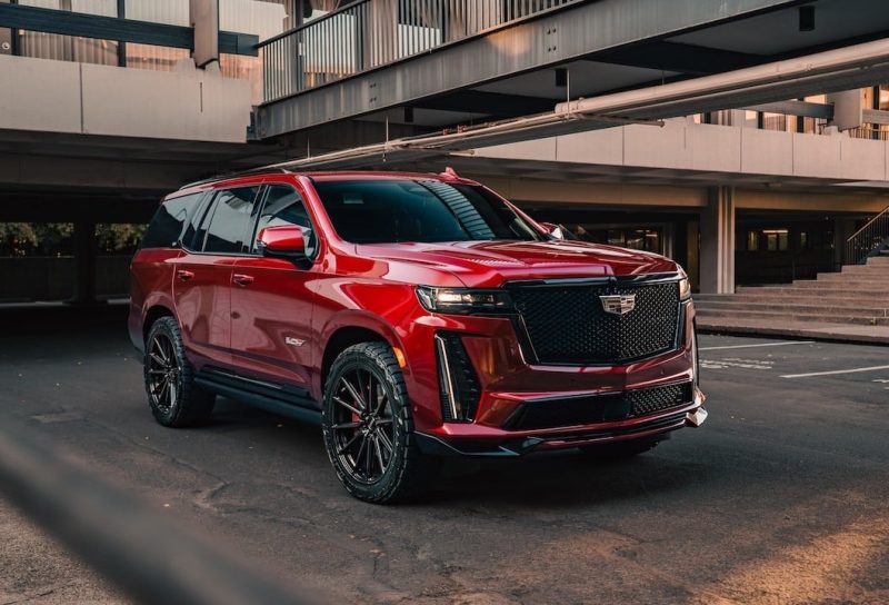 Cadillac Escalade V parked with a bridge in the background