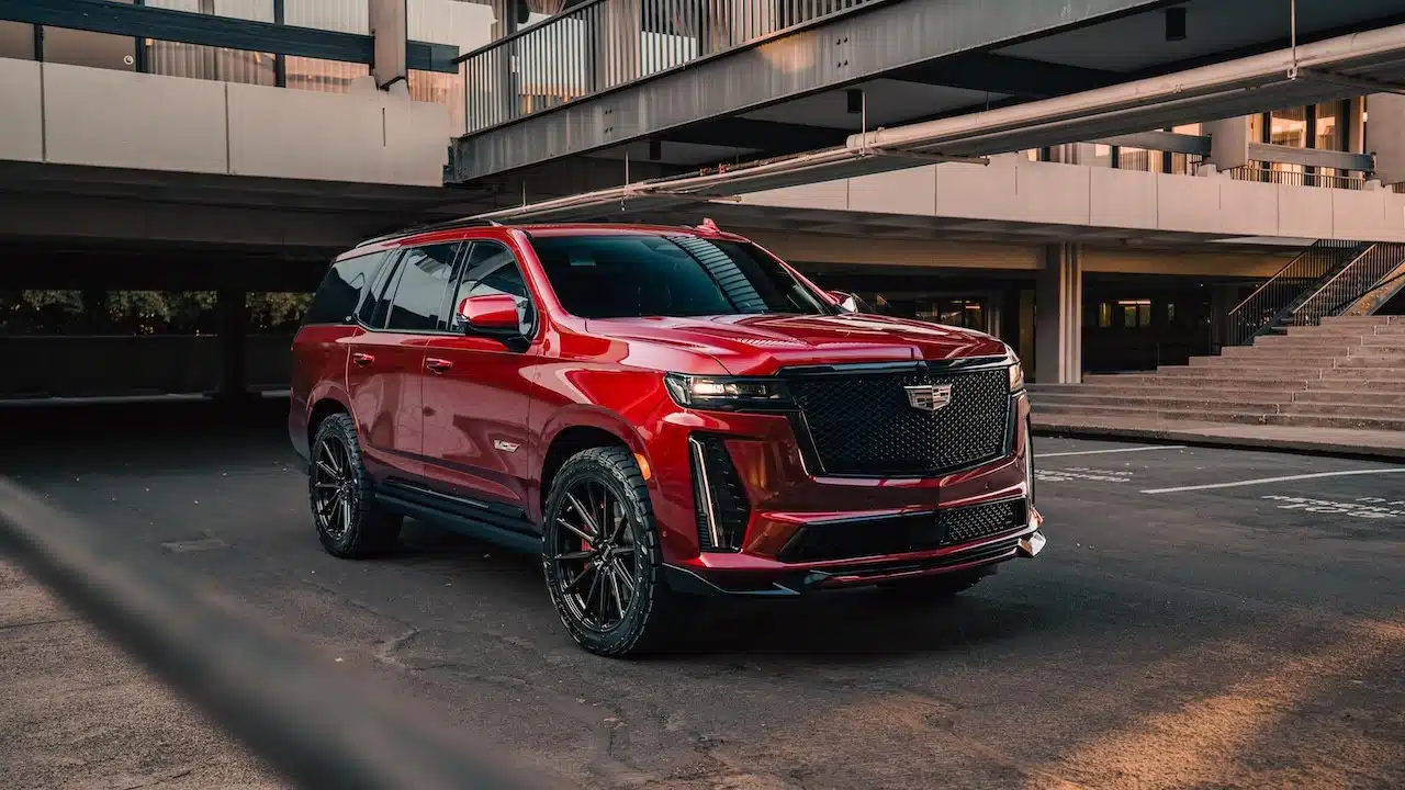 Cadillac Escalade V parked with a bridge in the background