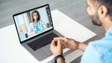 A man chatting with a doctor on a laptop, tele-health concept, representing LifeMD settlement.