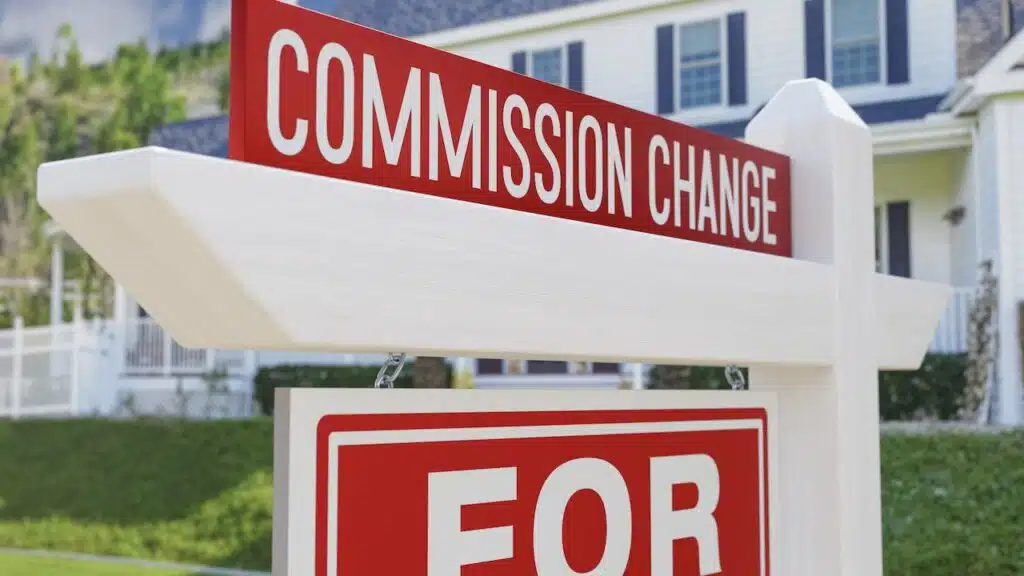 Commission Change For Sale Real Estate Sign In Front Of New House.