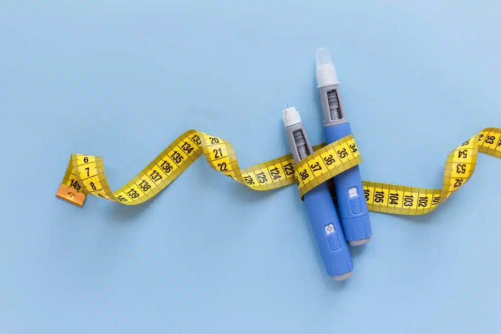 Close up of weight loss medication wrapped in a measuring tape, representing Roca Labs settlement.