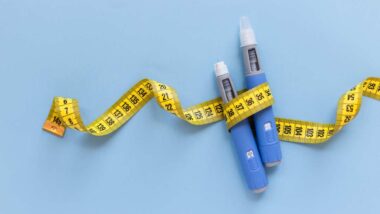 Close up of weight loss medication wrapped in a measuring tape, representing Roca Labs settlement.