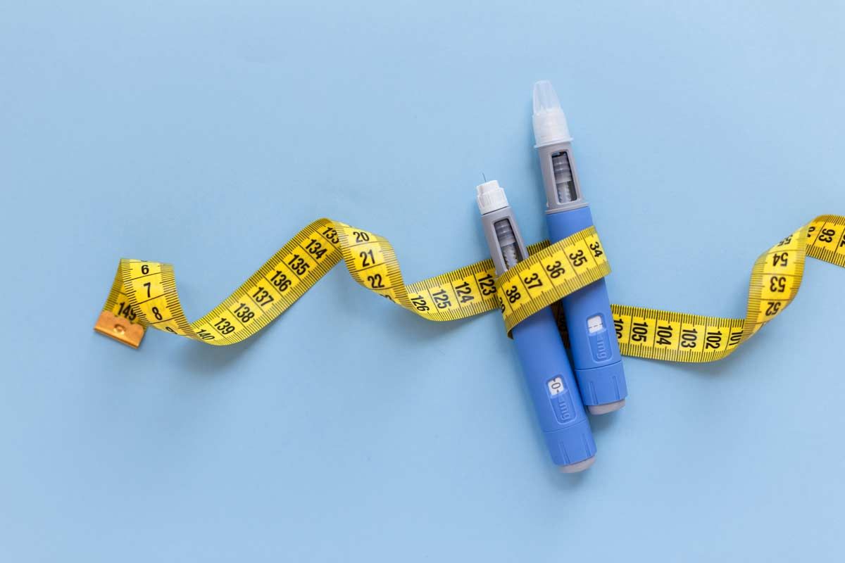 Close up of weight loss medication wrapped in a measuring tape, representing Roca Labs settlement.