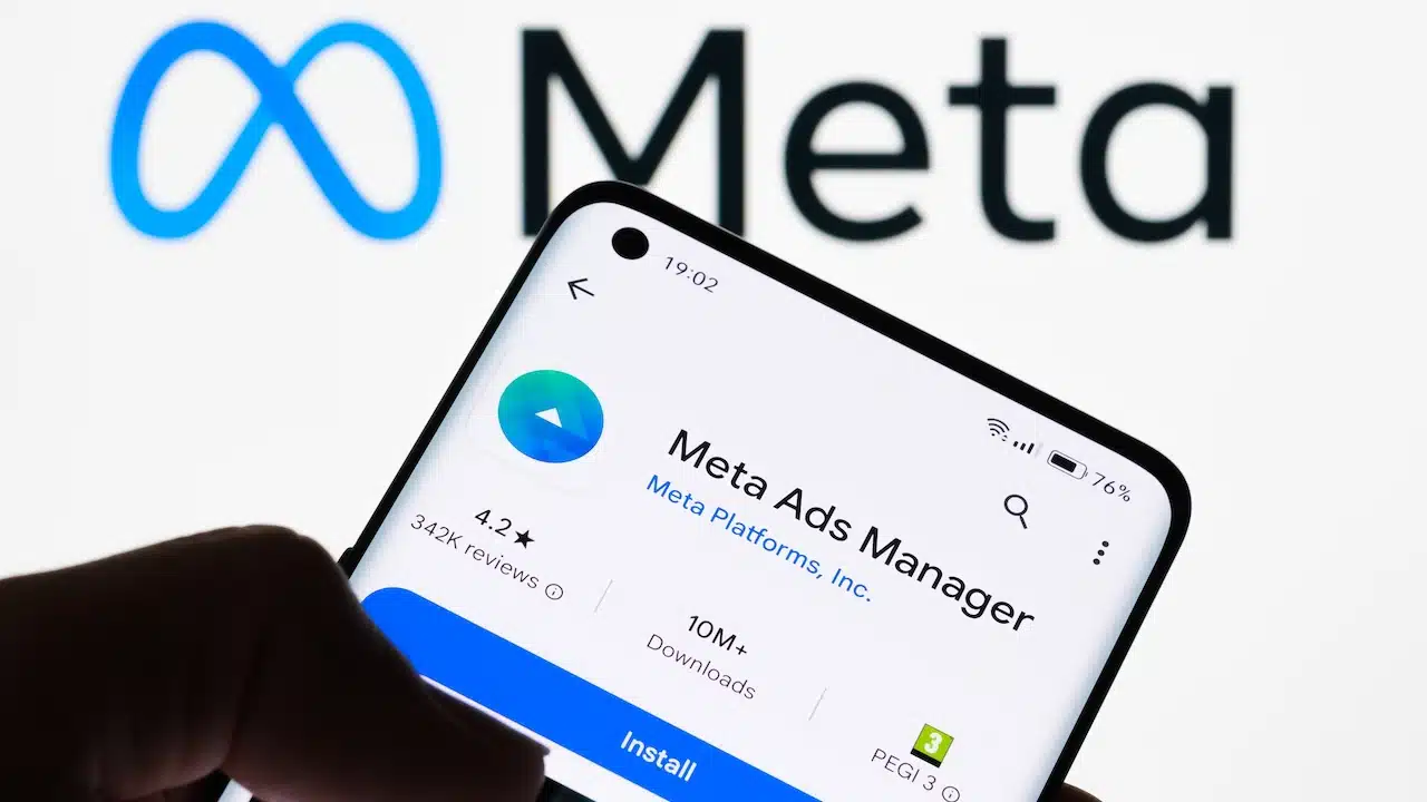 Meta Ads Manager app in app store with Meta logo in the background