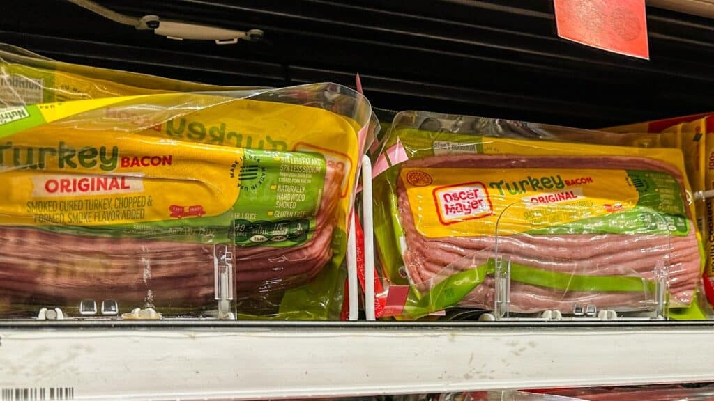 Packages of bacon on a store shelf