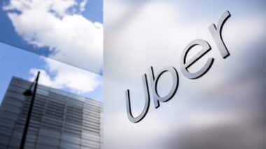 Uber logo on a sleek, reflective wall with urban high-rises in the background, representing modern transportation and technology innovation. Uber headquarters offices