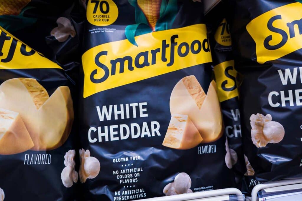 Close up of Smartfood White Cheddar popcorn on a supermarket shelf, representing Smartfoods class action.
