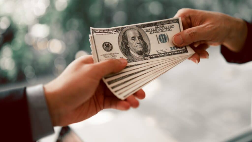 Hands passing money
