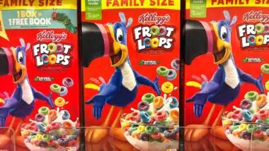 Grocery store shelf with boxes of Kellogg's brand cereal, Froot Loops.