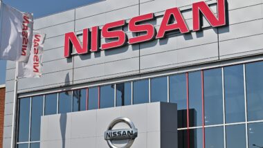A wall sign for the Japanese car manufacturer Nissan at a dealership