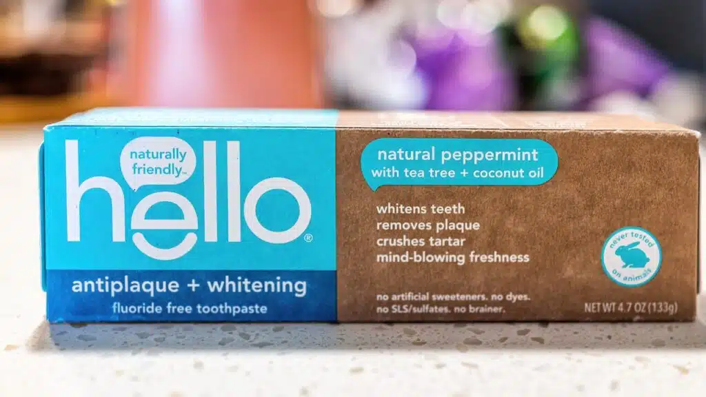 Macro closeup of Hello flouride free toothpaste package on table with sign text of product for antiplaque and whitening