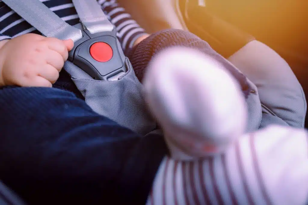 Close-up of baby sitting in car seat