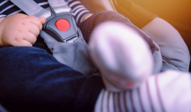 Close-up of baby sitting in car seat
