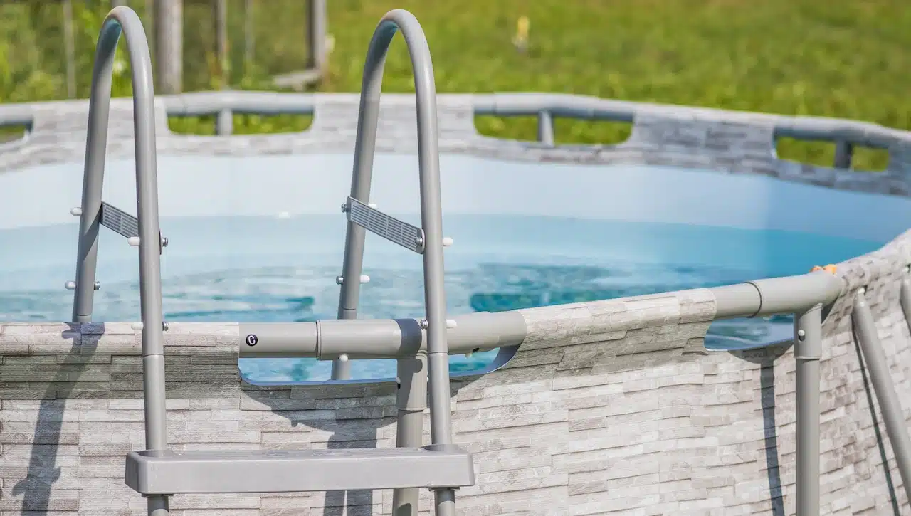 A peaceful aboveground pool complete with a ladder, inviting you to relax and enjoy fun activities outdoors