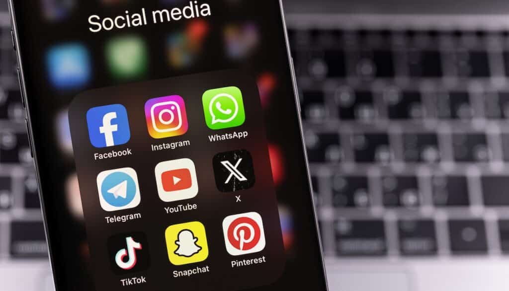 smartphone with mobile apps Facebook, Instagram, WhatsApp, Telegram, YouTube, Twitter X, TikTok, Pinterest.