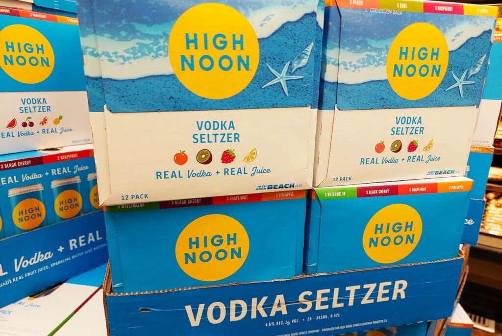 HIGH NOON Vodka Seltzer, boxes of canned vodka with real fruit juice on sale inside a supermarket