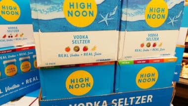 HIGH NOON Vodka Seltzer, boxes of canned vodka with real fruit juice on sale inside a supermarket