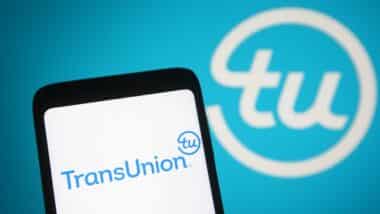 TransUnion Holding Company, Inc logo is seen on a mobile phone and a computer screen.